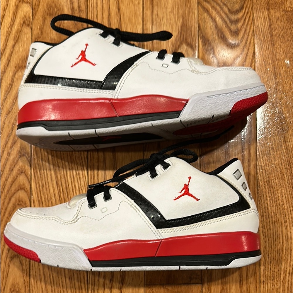 Jordan Nike Kids White and Red Sneakers with Black Accents size 2Y.